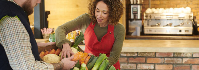 A restaurateur picking fresh produce from a seller
