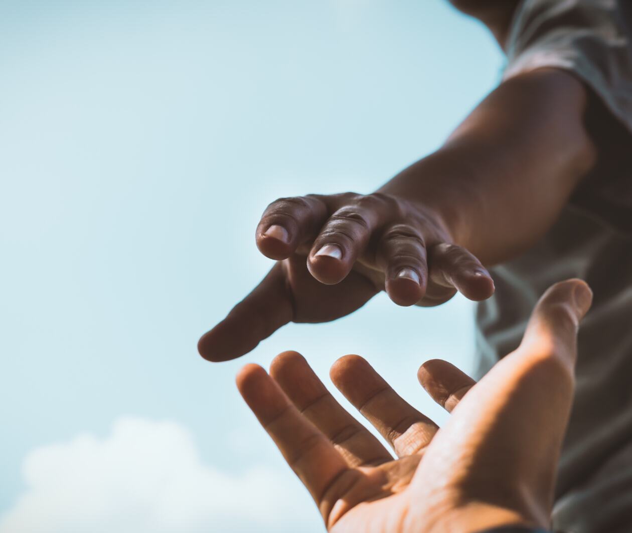 Two hands reaching out to one another.