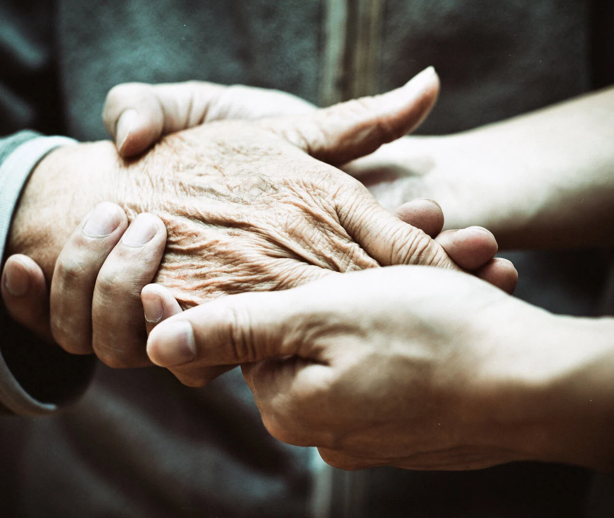 Elderly hand and caregiver