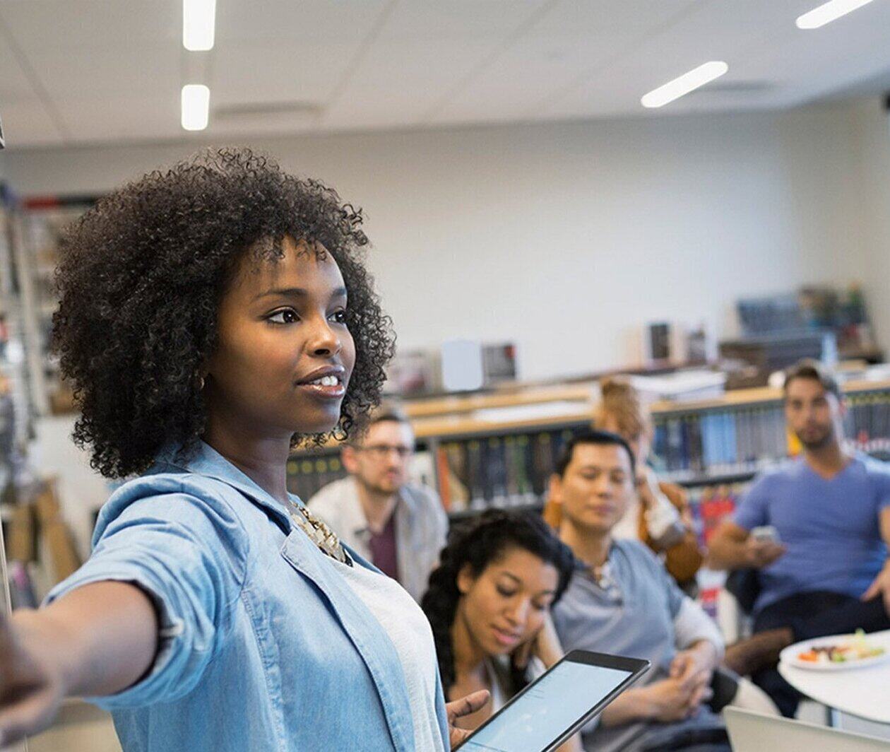 woman presenting from a whiteboard