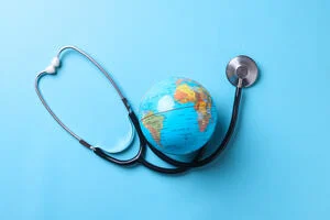 Globe with stethoscope isolated on blue background. Save the wold, Global healthcare and Green Earth day concept.