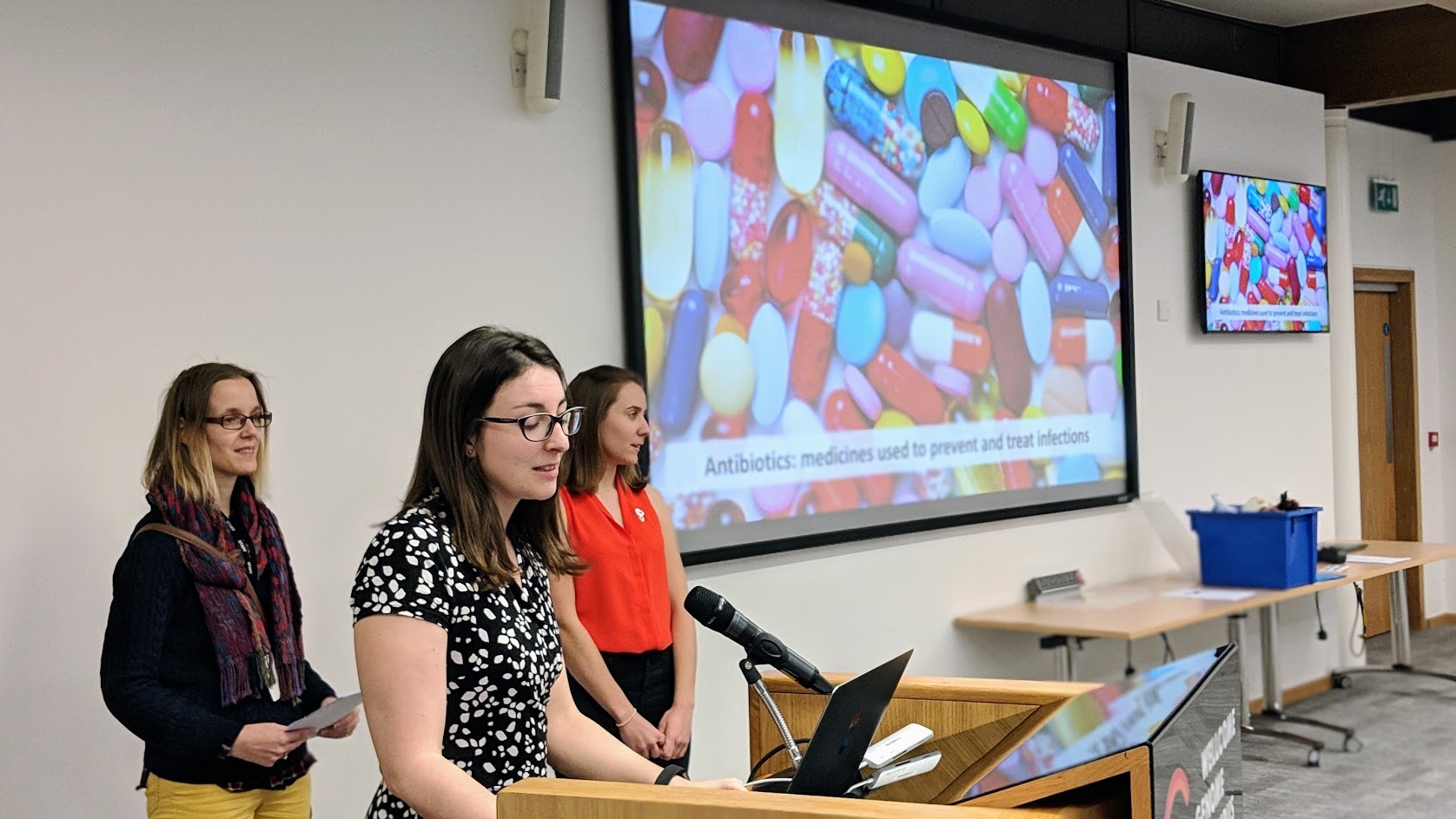 Trainers in from of a screen showing a photo with colourful medicines