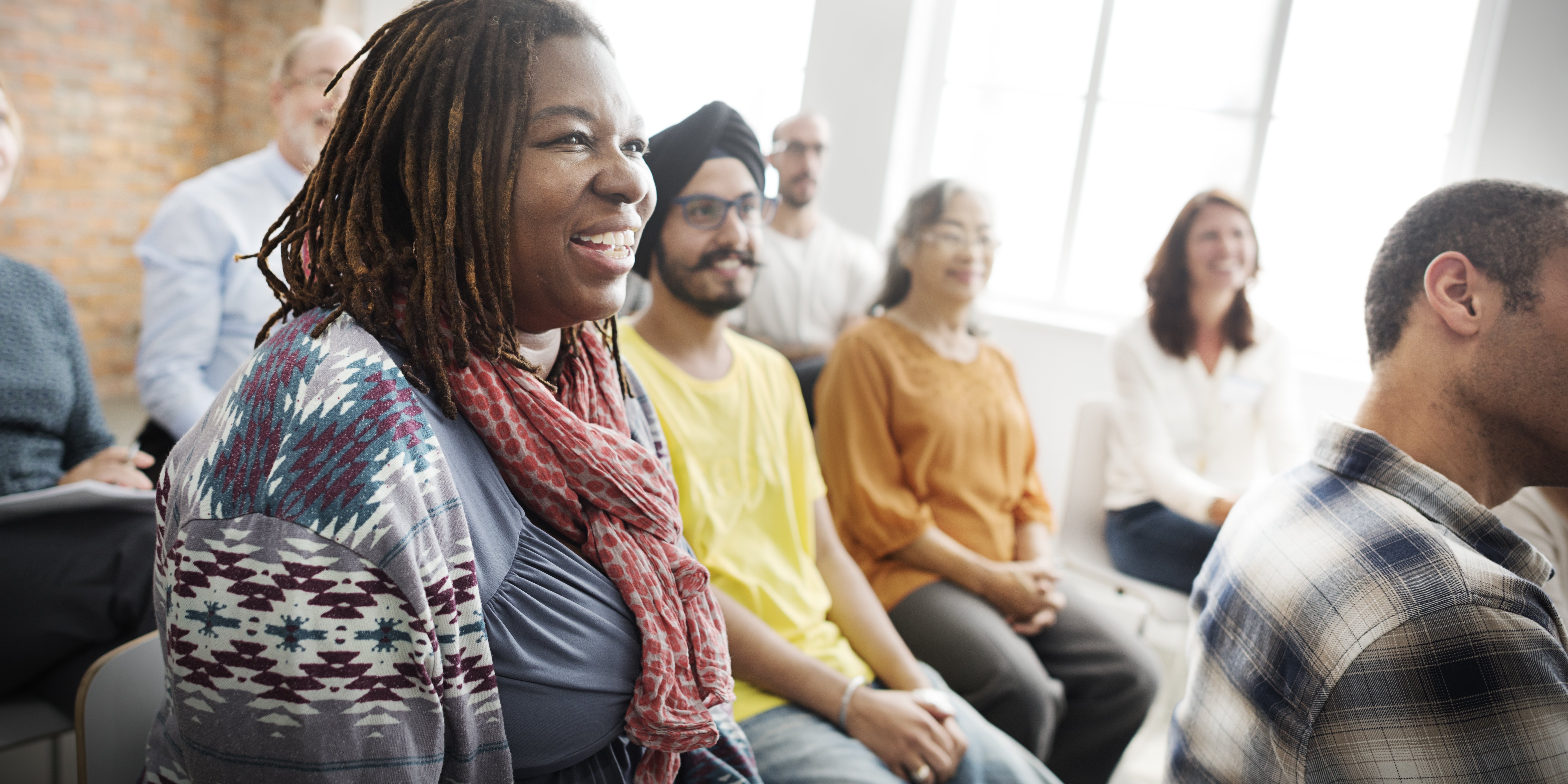 Smiling people sitting in a support group