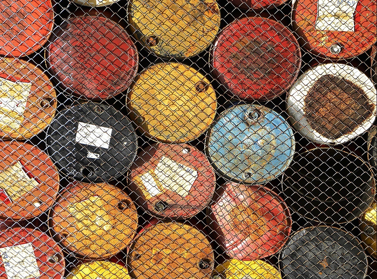 Oil barrels stacked behind wire fence