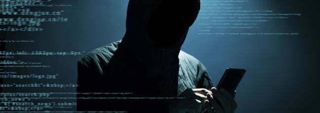 Image of shadowy person using mobile phone