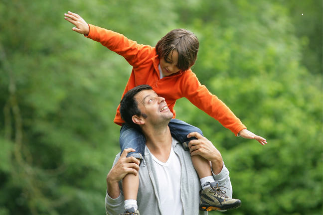 Man and boy laughing together