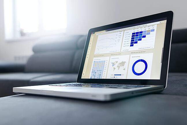 A laptop with graphs on the screen