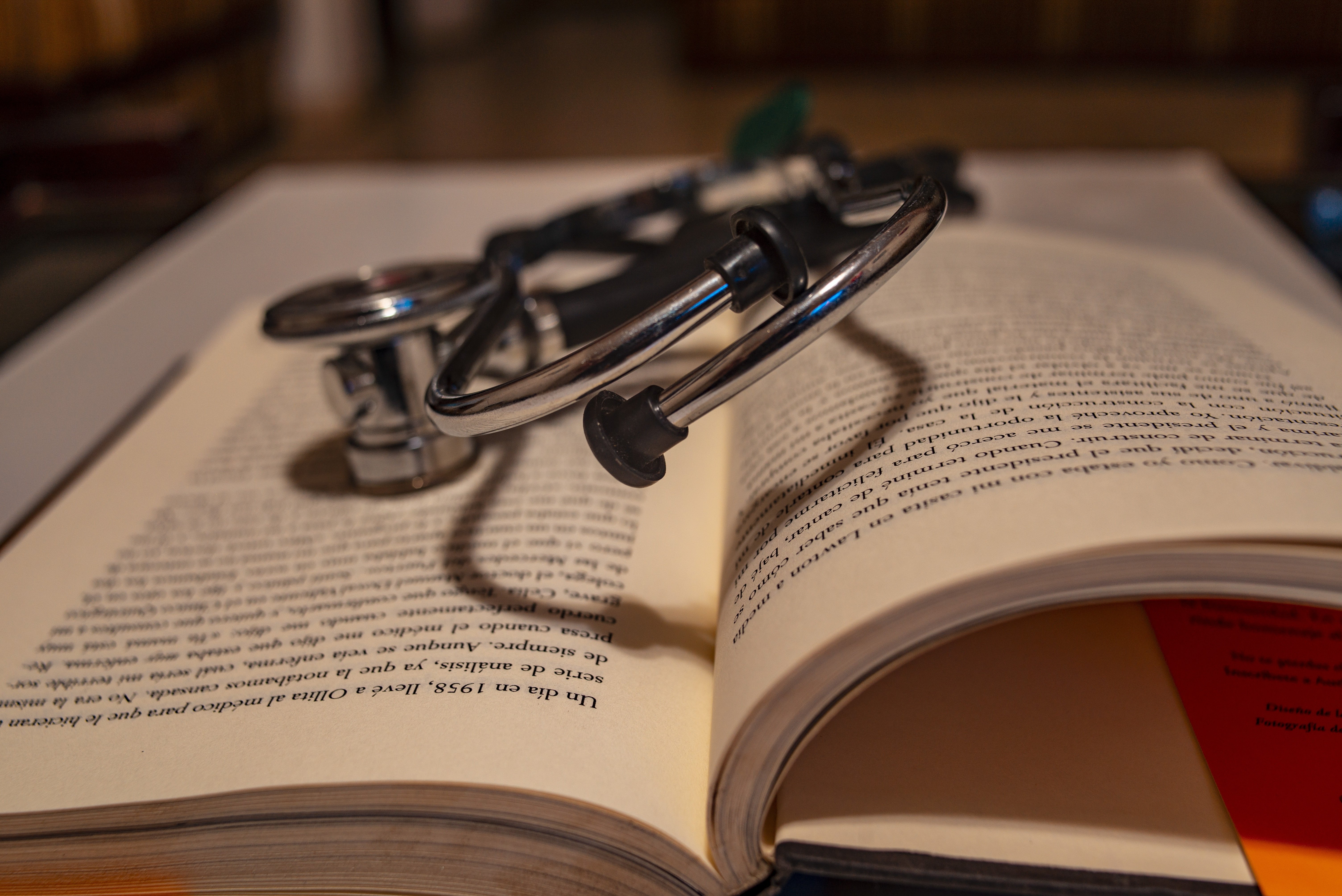 Language and health communication are increasingly recognised as topics of importance to clinicians. A stethoscope lying on top of an open book.