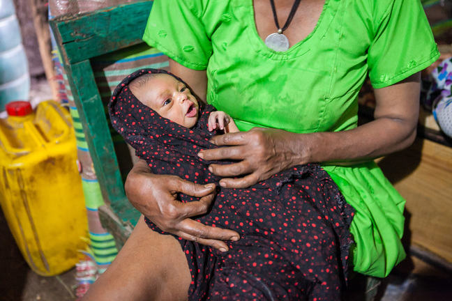 Image of a newborn baby wrapped in a blanket.