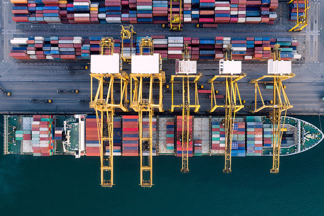 Containers craned onto ship at docks