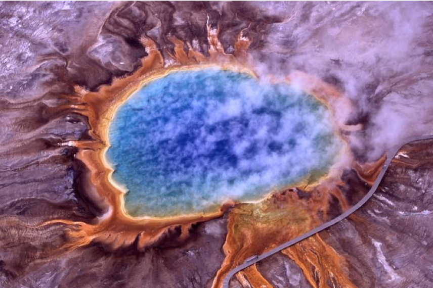 Extremophilic algae turn the edges of this volcanic hot spring orange. Grand Prismatic Spring, Yellowstone National Park.