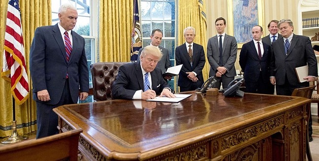 Donald Trump signing Mexico City policy, surrounded by other white men.