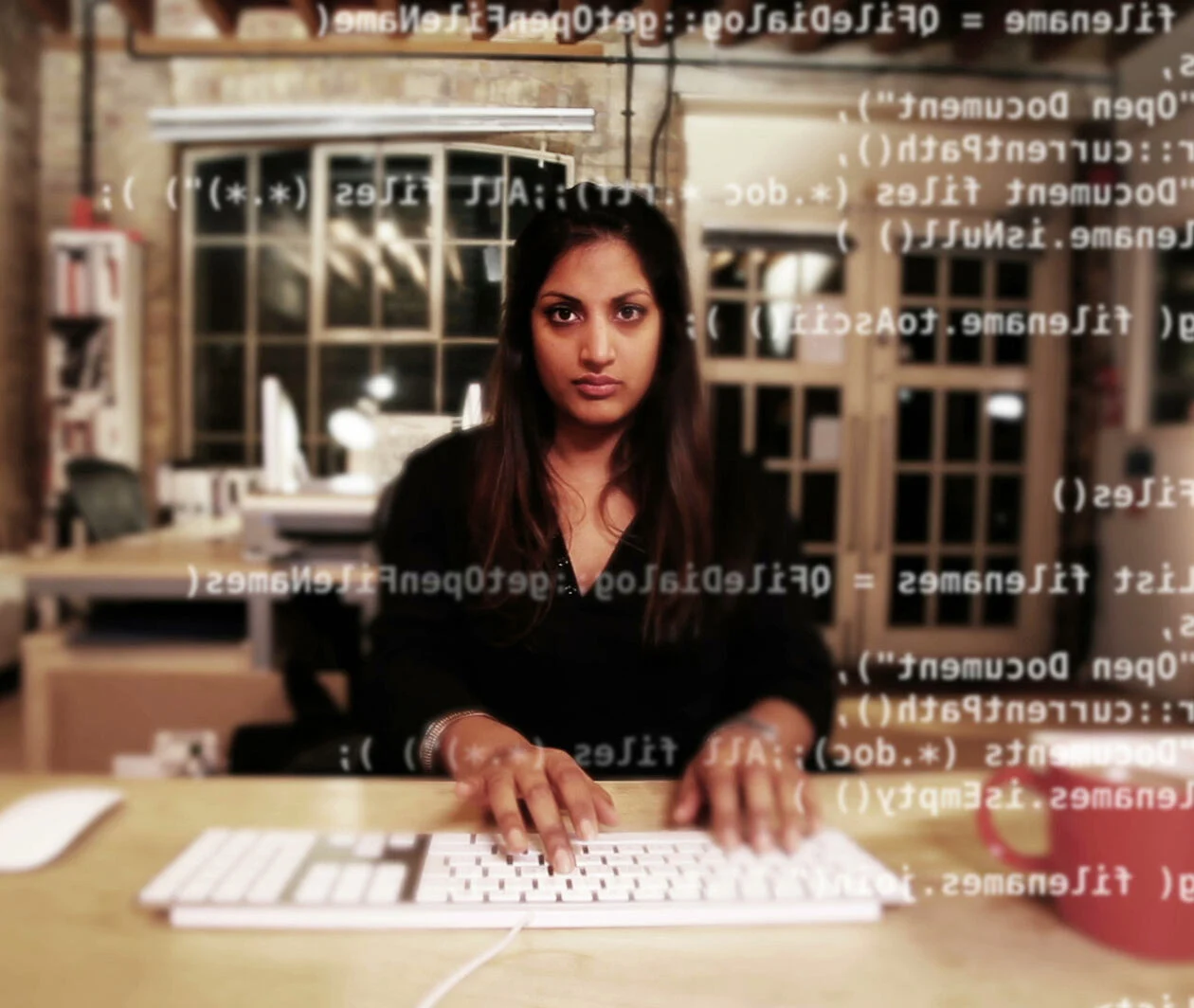 A person analysing malware code on a computer