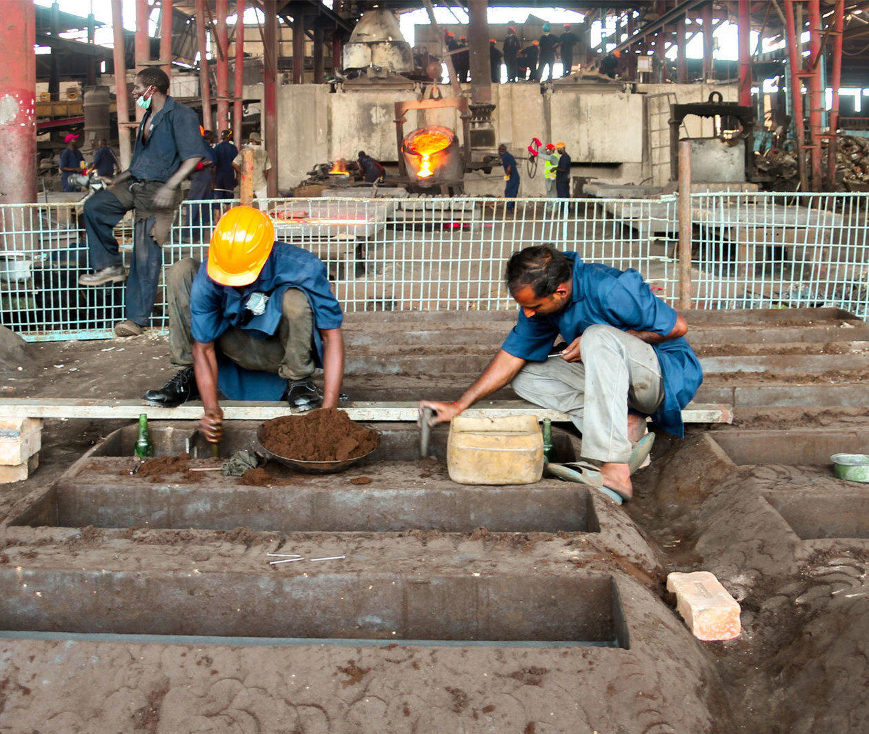 Occupational health: two men working in a factory in a developing country