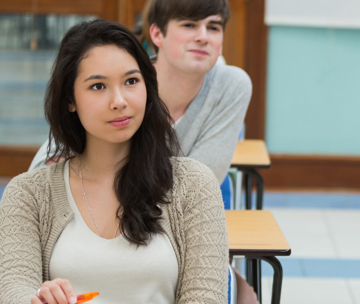 A student in the classroom listening to the teacher 