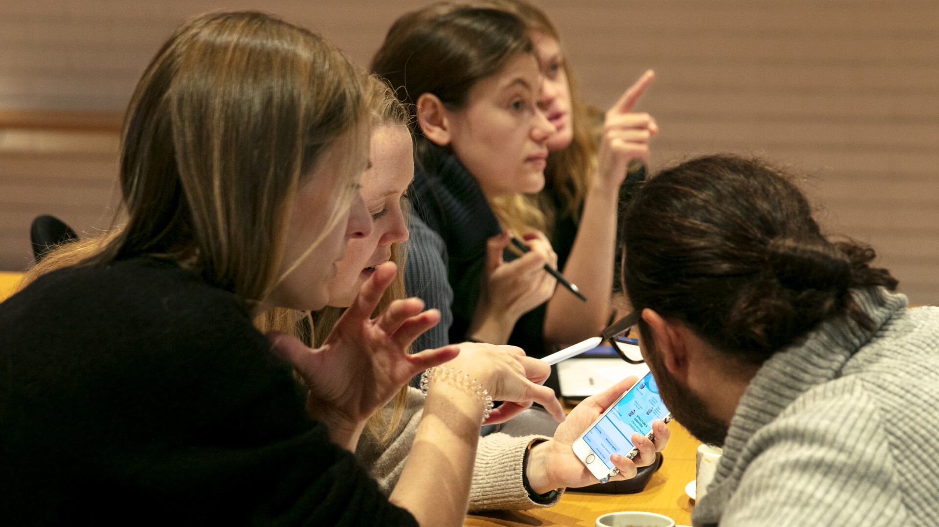 People talking to each other at a table.