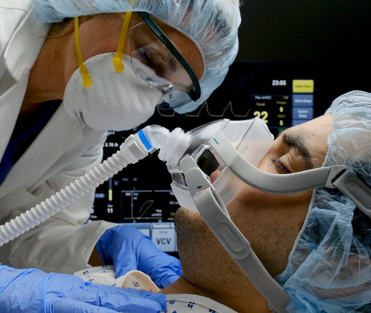 Doctor with patient on a respirator