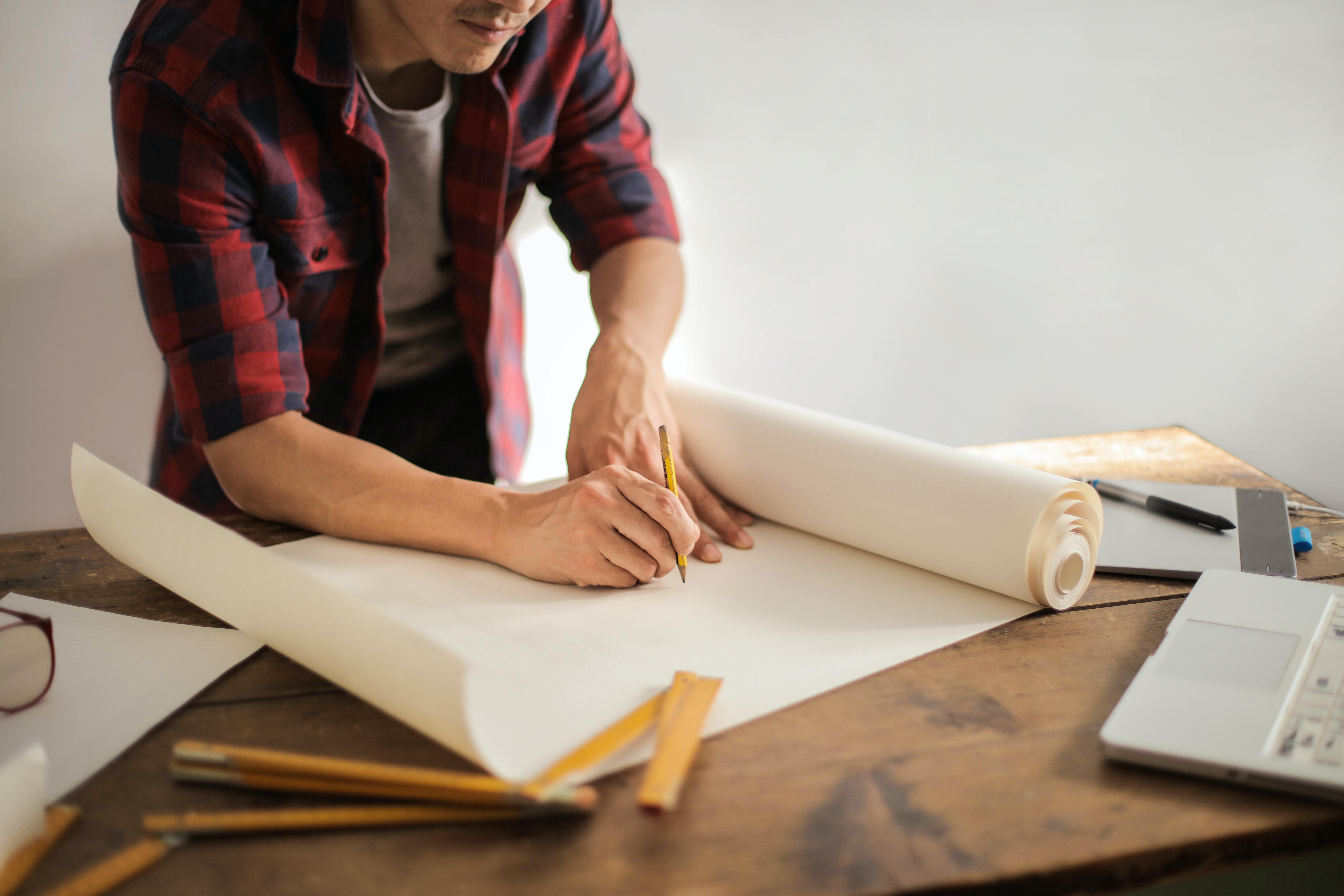 a man holding a blank sheet to start to draw something