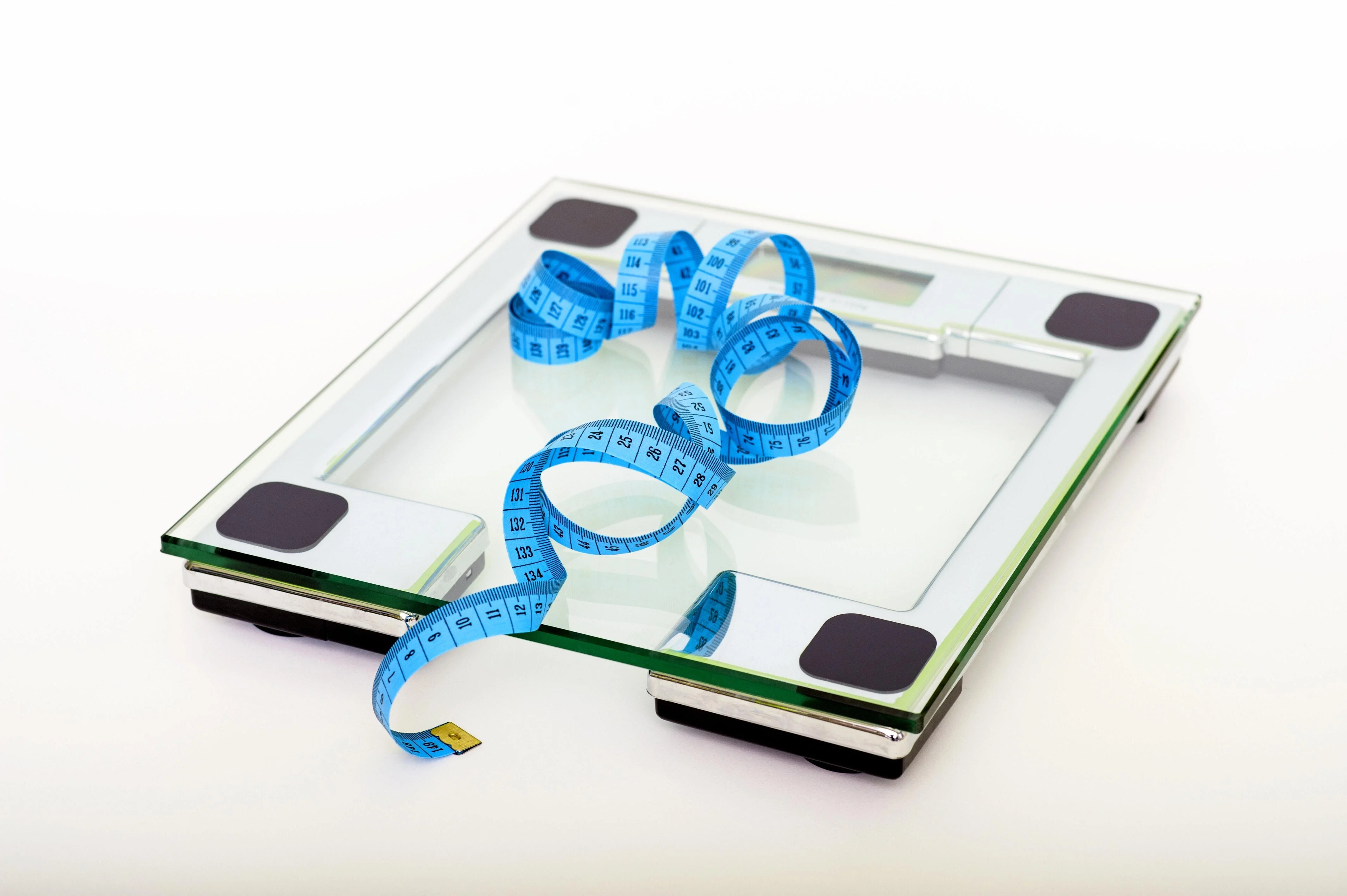 a scale and tape measure on a white floor