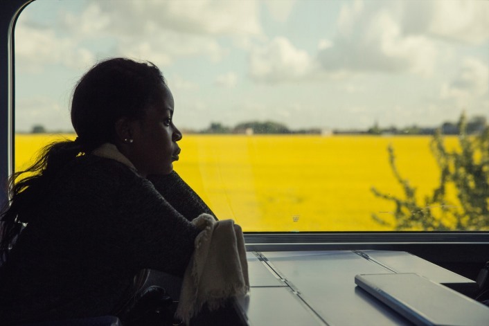 Lady on train looking out of window