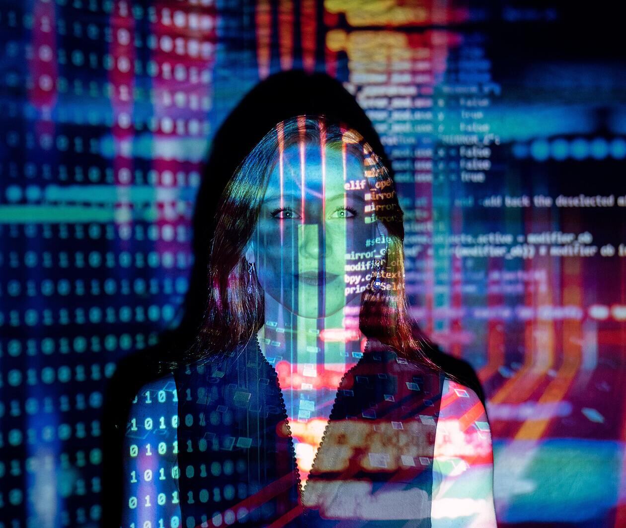 visual of computer code projected over woman's face