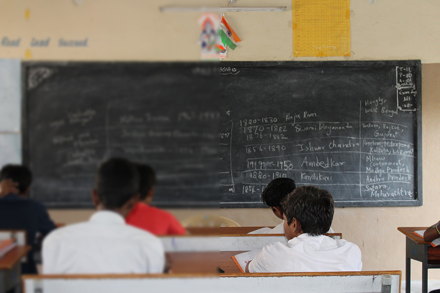 Blurred out writing on a classroom blackboard shows how poor vision can affect learning at school.