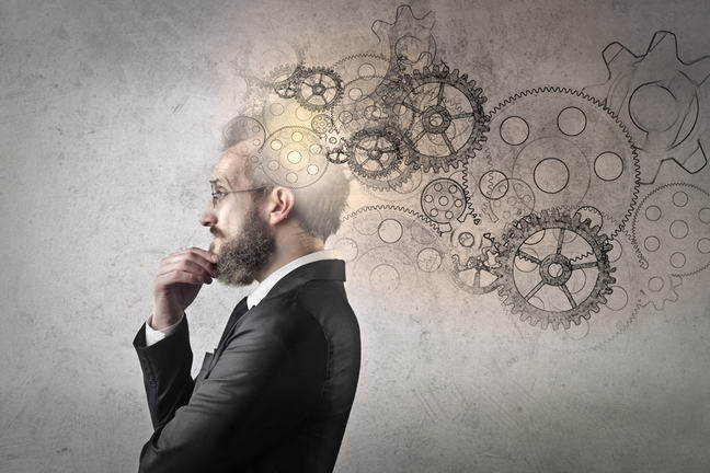 Man thinking surrounded by images of cogs