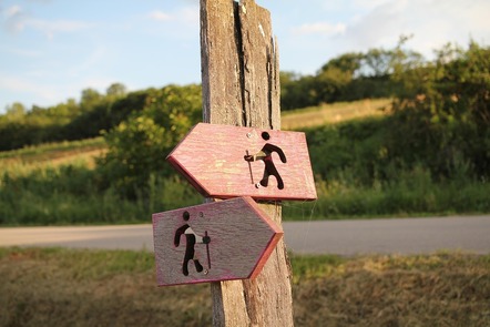 A sign pointing both left and right with little walking figures going in each direction