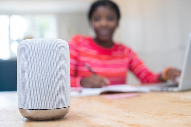 Teenager using a digital home assistant