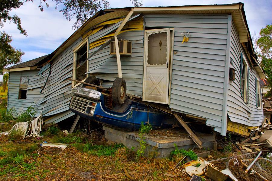 Crumpled house on top of a car resulting from a storm