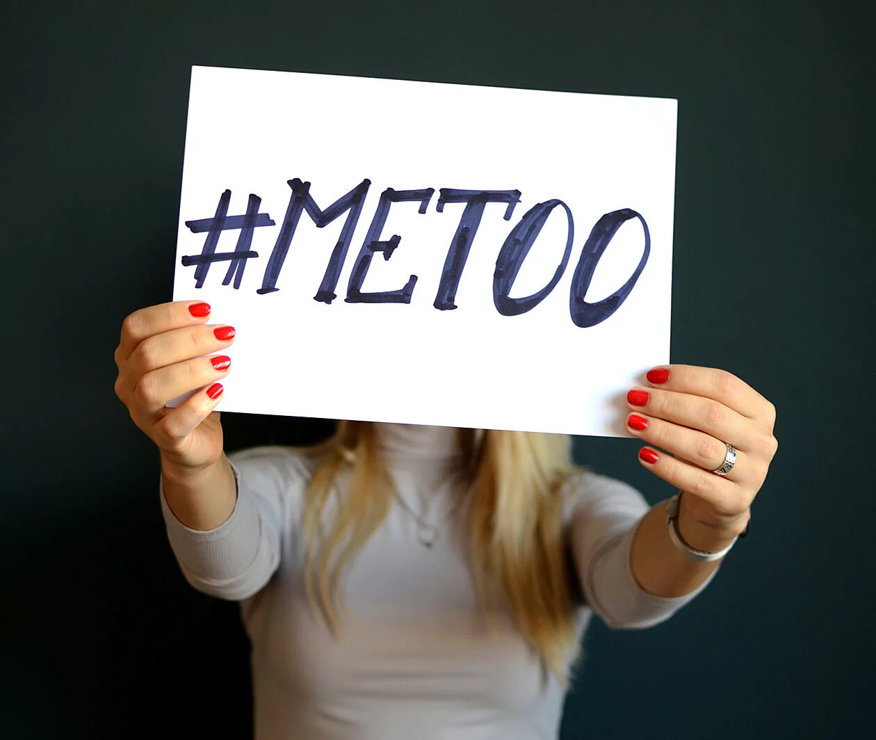 Person holding a sign with the text #METOO