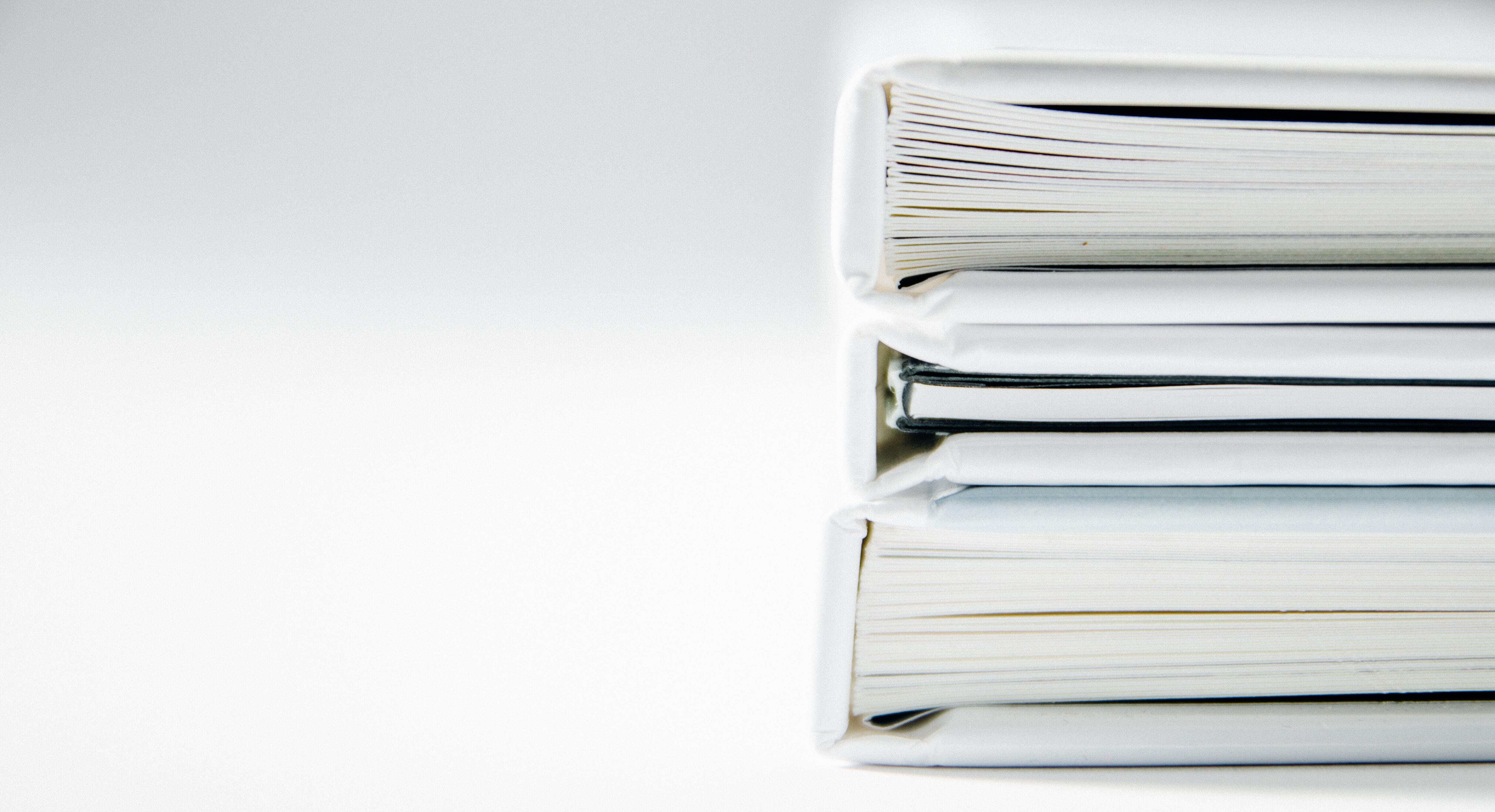 pile of white books against white background