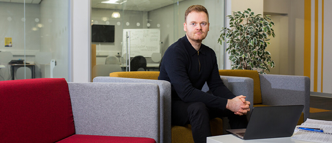 Image of a man sitting on a sofa