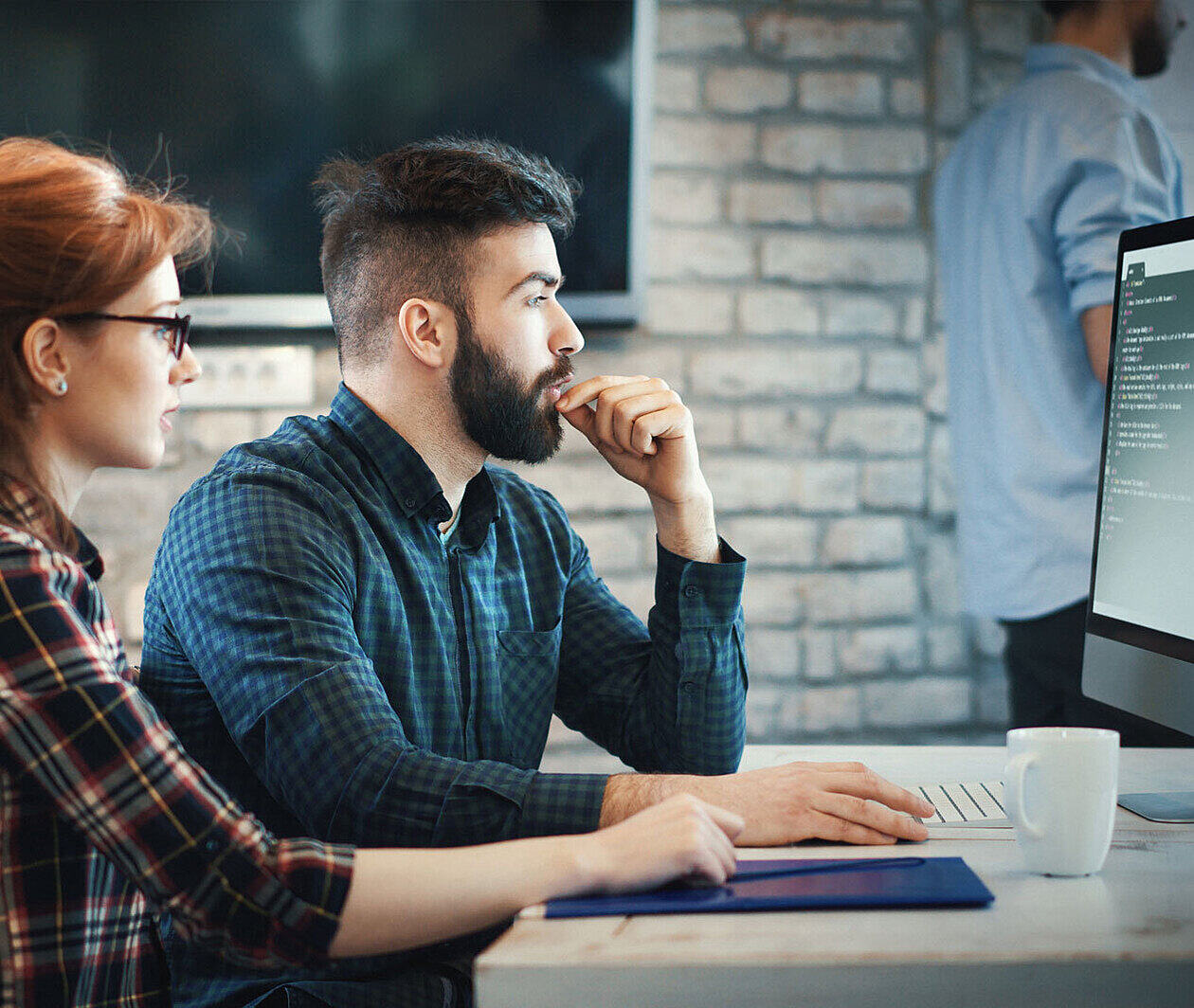 Man and woman looking at a computer screen.