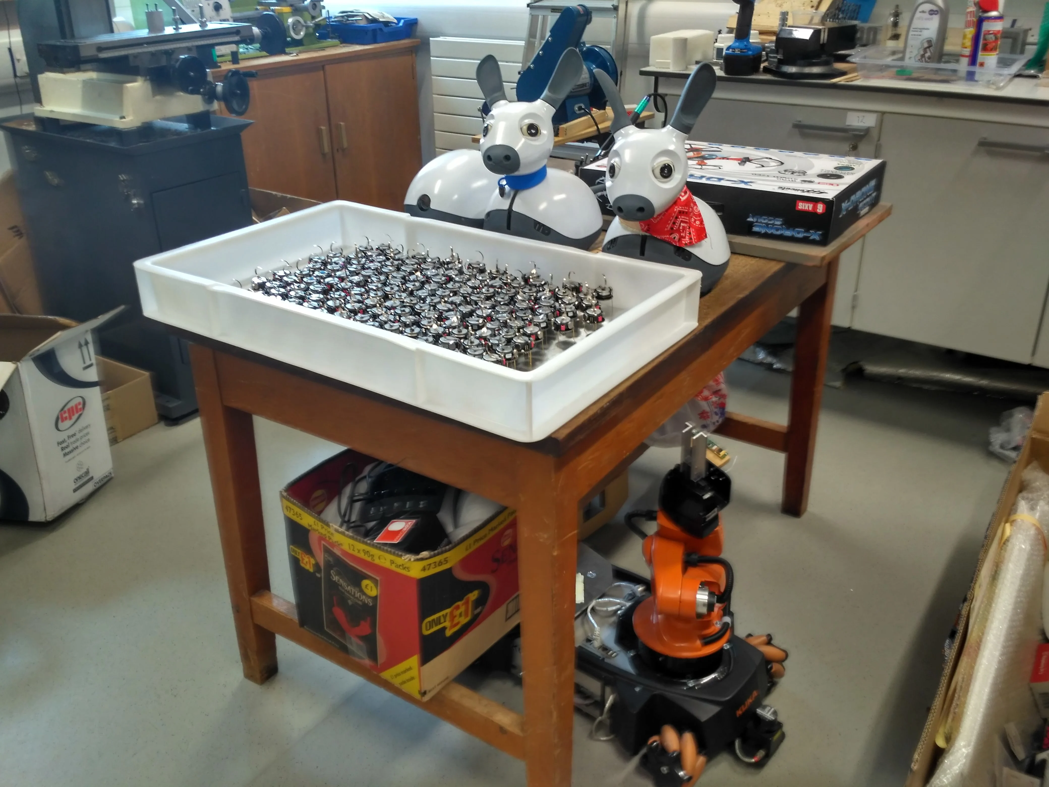 Different types of robots all packed away in a workshop