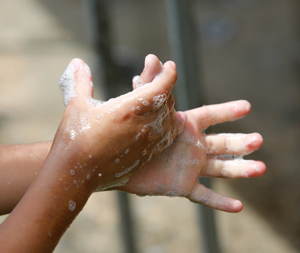 A close up of a child washing hands