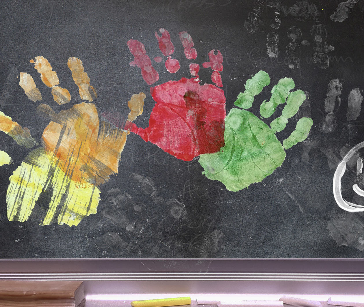 School blackboard with colourful handprints