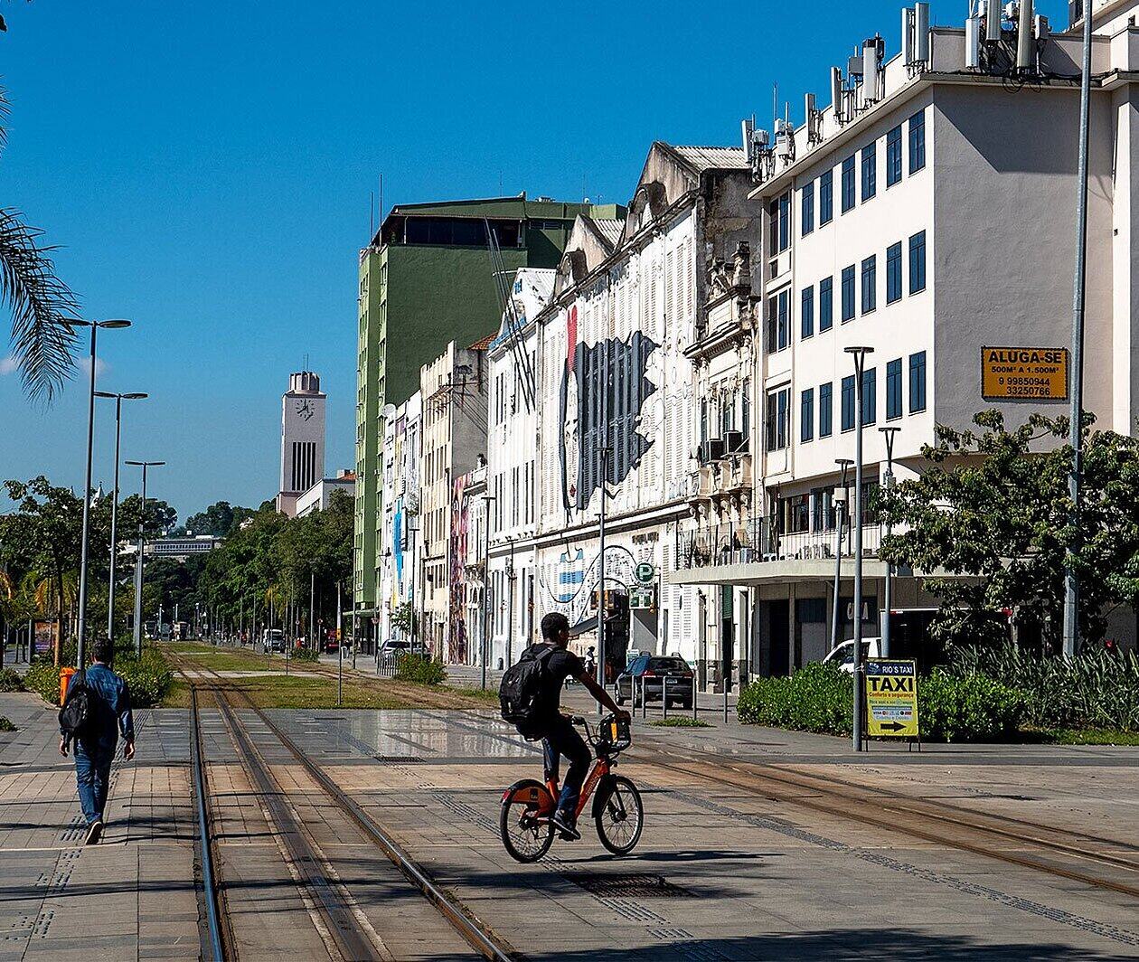 Someone cycling between tramlines on a street 