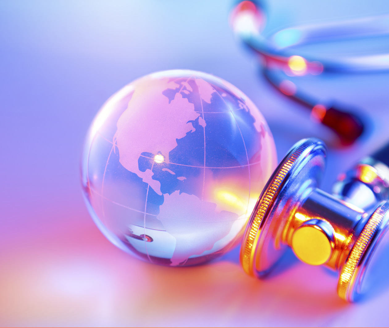 A crystal ball with image of the Earth superimposed on it with a stethescope next to it