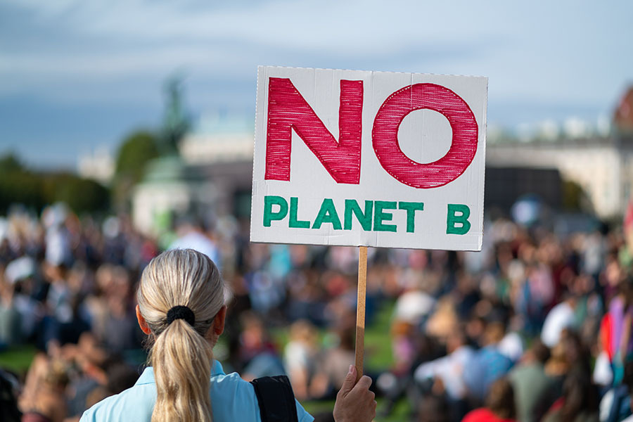 Climate protestor holding sign No Planet B