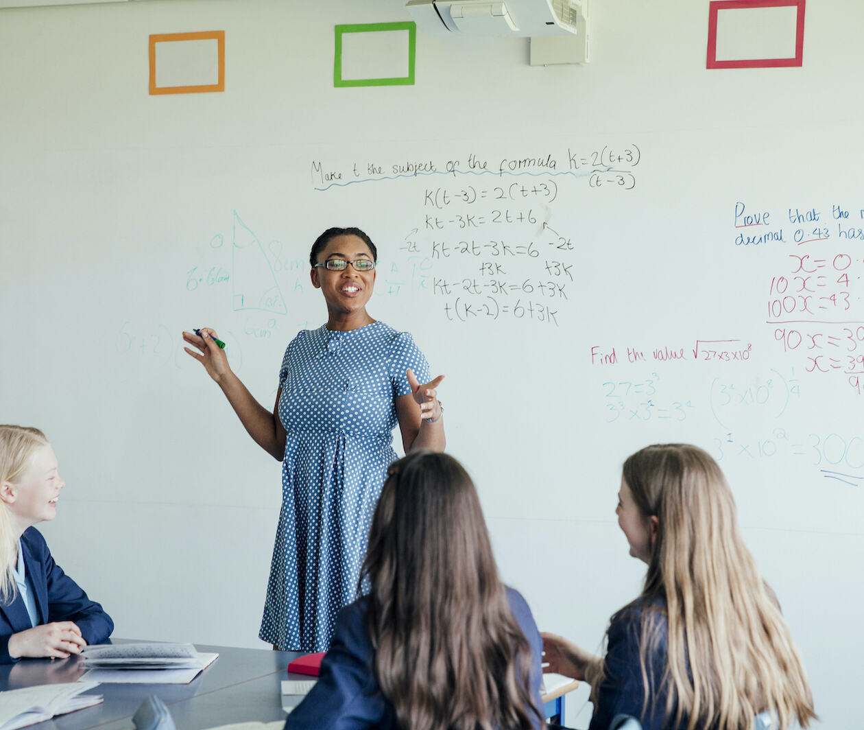 Young teacher standing in front of a class of pupils