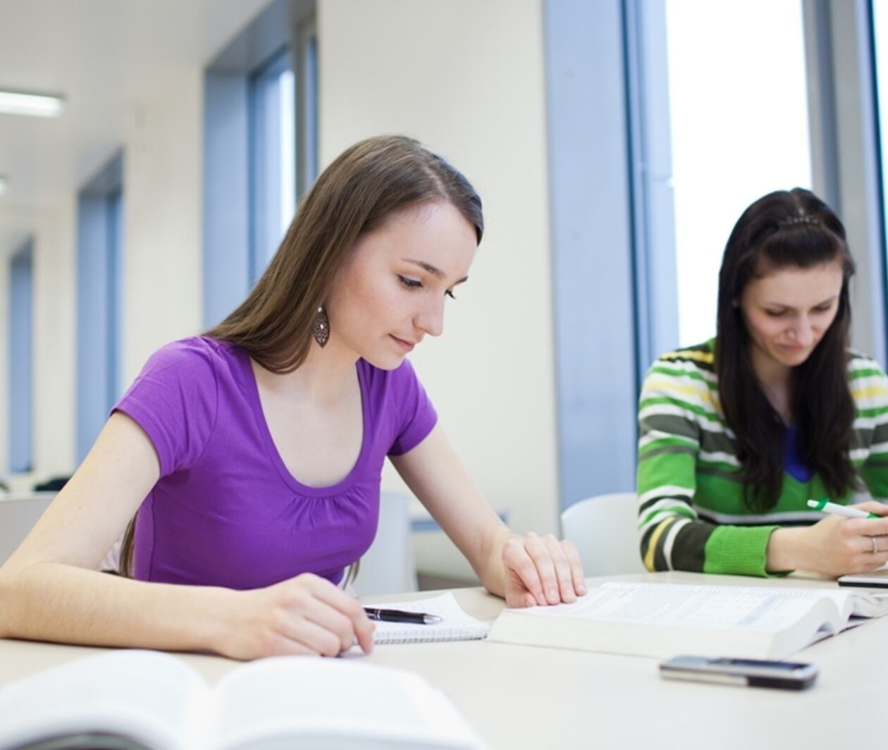 Two students are studying in a classroom 