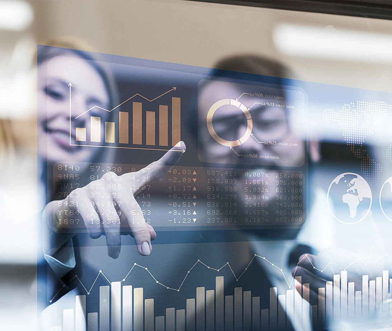 Two people smiling and pointing at charts on a screen.