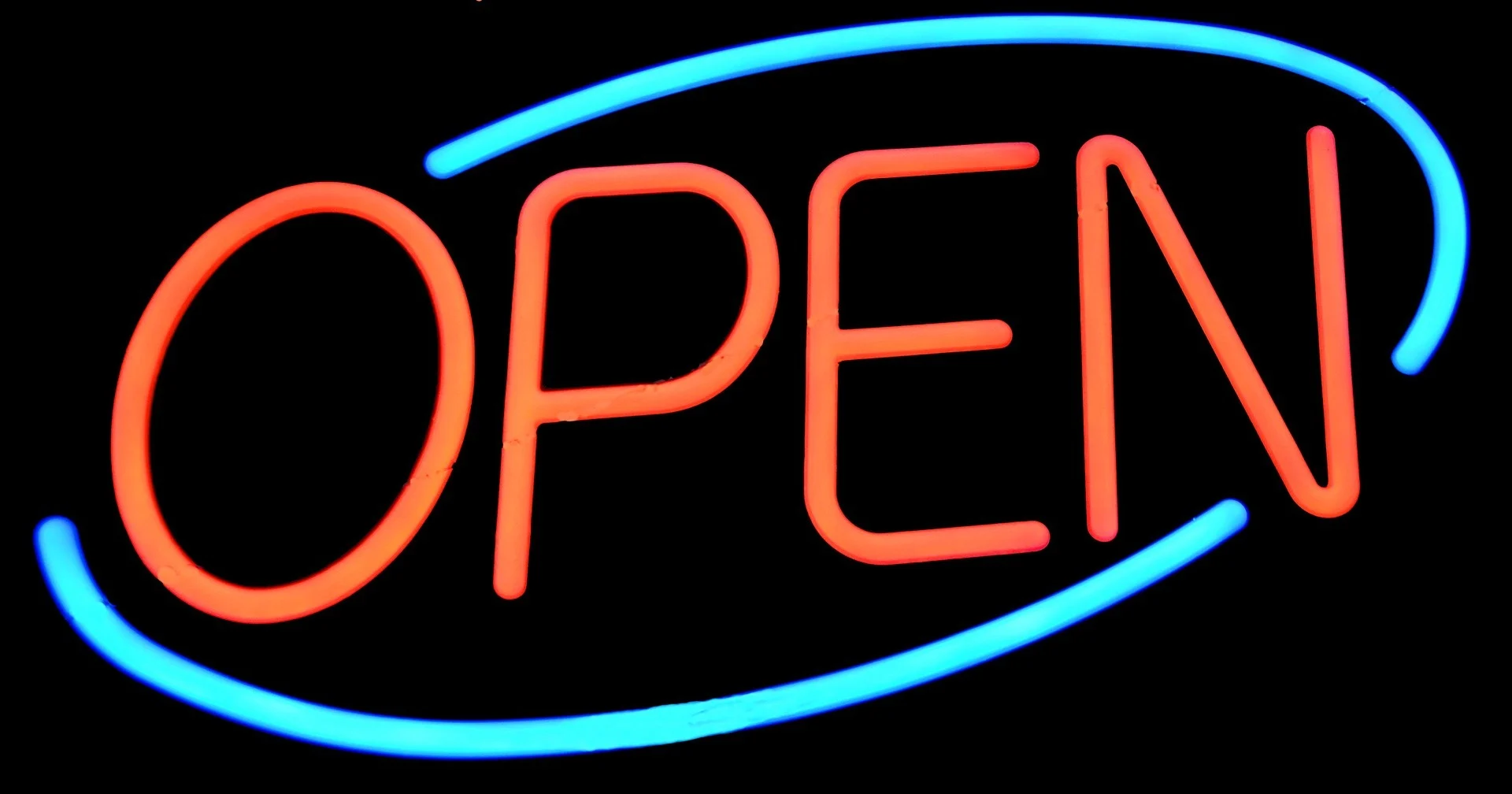 A illuminated neon 'Open' sign