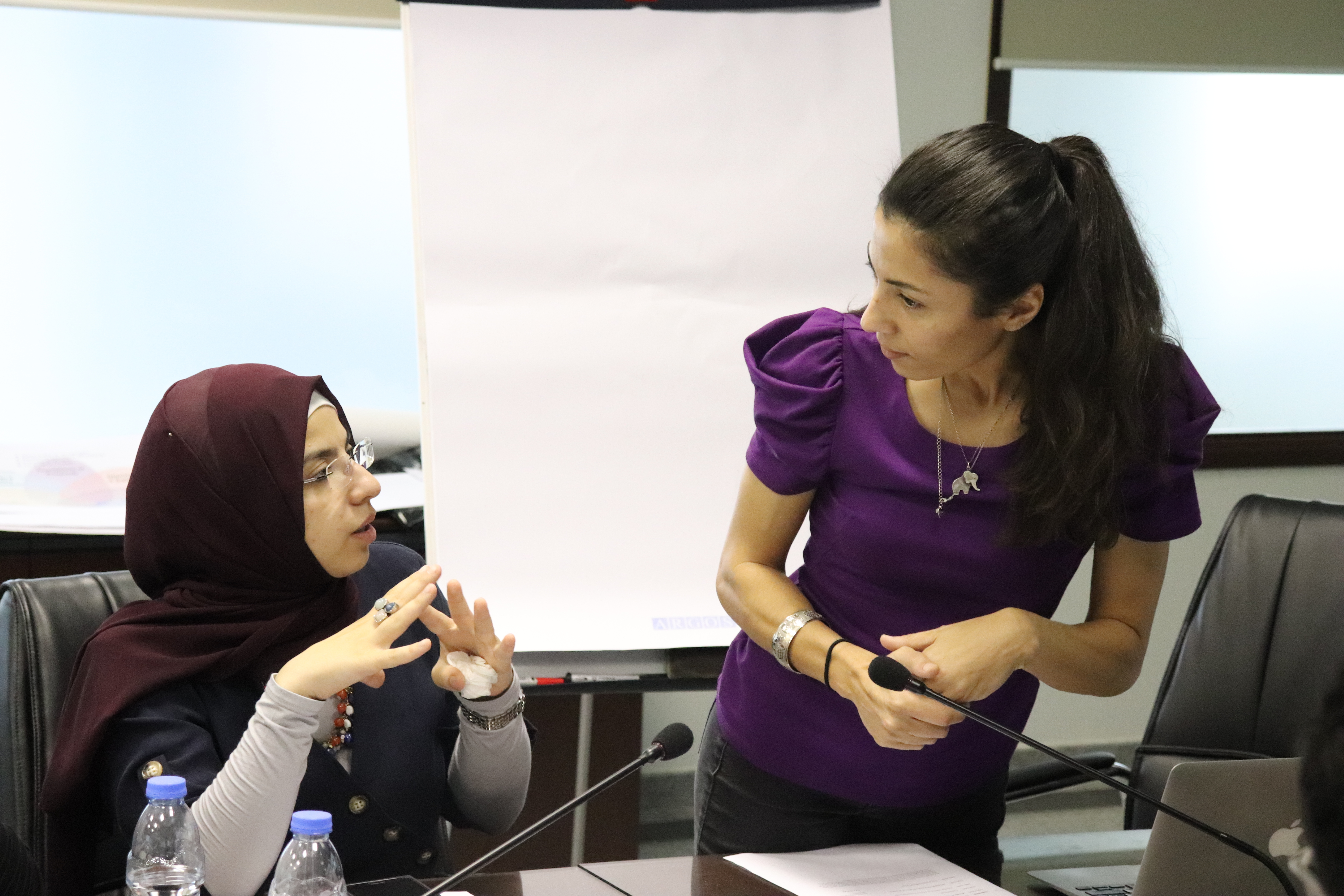 A woman being asked a question by another