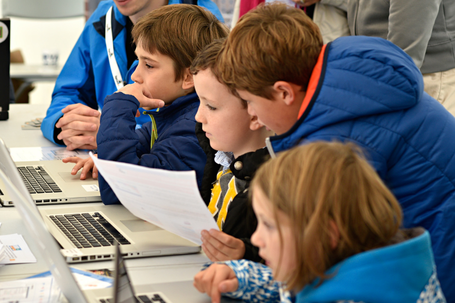 Children learning at laptops