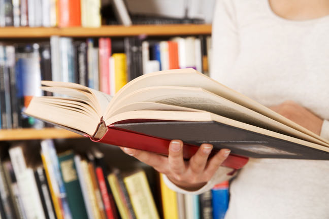 Woman holding a open book.