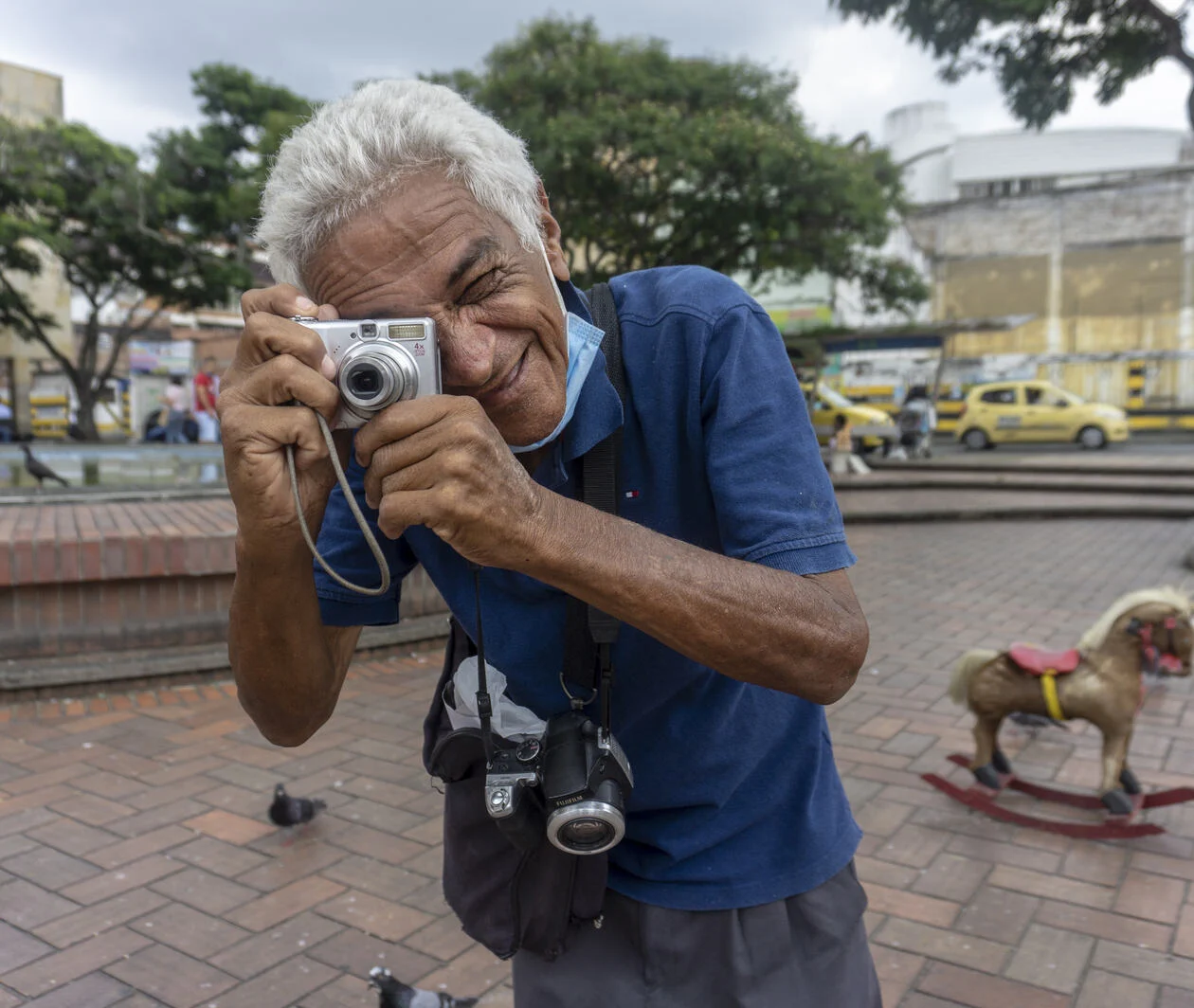 Photograph of a photographer standing in a paved area