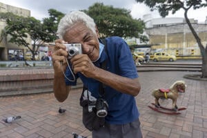 Photograph of a photographer standing in a paved area