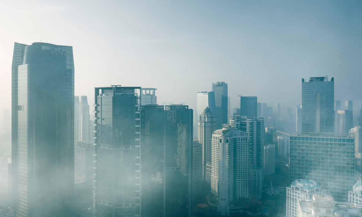 City skyscrapers with smog and air pollution all around the buildings.